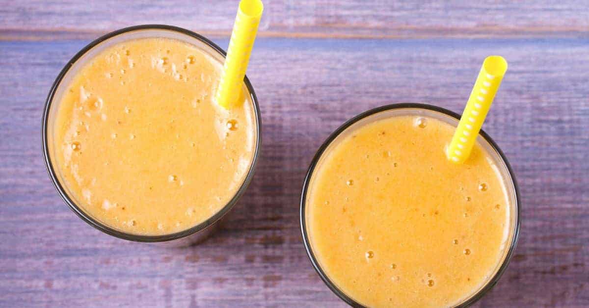 Easy Peach Smoothie Without Yogurt - top down images of 2 peach smoothies recipe on a table