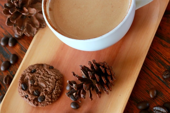 hot chocolate sitting on a table with a cookie Homemade Hot Chocolate Recipe