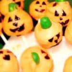 Pumpkin Cake Pops for Halloween pumpkin cake pops with faces sticking into a stand