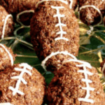 Chocolate Football Rice Krispie Treats rice crispy treats shaped like footballs on a plate