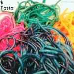Rainbow Pasta on a plate in blue pink green and orange