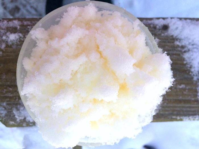 easy recipe for snow ice cream (snow ice cream with milk sugar and vanilla) - aka: snow storm ice cream dish of snow cream on a table in the snow