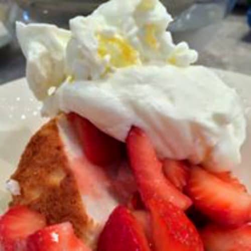 Homemade Whipped Cream Recipe (Plus a Secret Recipe Ingredient) homemade whipped cream on strawberries