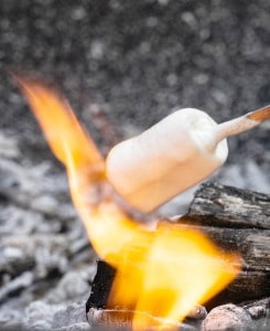 How to Make Smores a marshmallow roasting over the fire