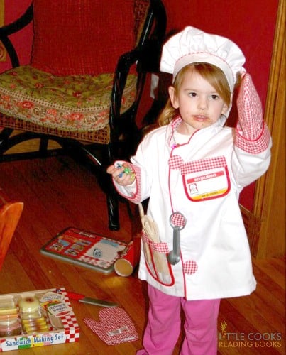 my toddler daughter in her mini chefs outfit