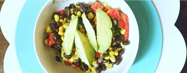 How To Make Black Bean and Corn Salad (recipe corn and black bean salad) bowl with black bean and corn salad topped with avocado