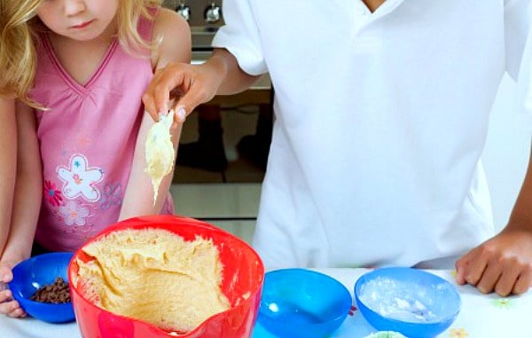 Cooking Classes for Kids hands of kids stirring cookie dough