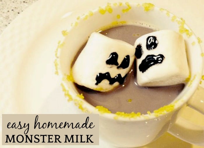 Easy Homemade Chocolate Milk with floating marshmallow ghosts in a white mug