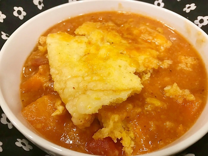 Crock Pot Sweet Potato Soup with cornbread dumplings in a white bowl