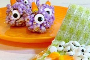 Easy Recipe for Popcorn Balls with Marshmallow For Halloween Treats purple people eater popcorn balls recipe on an orange plate