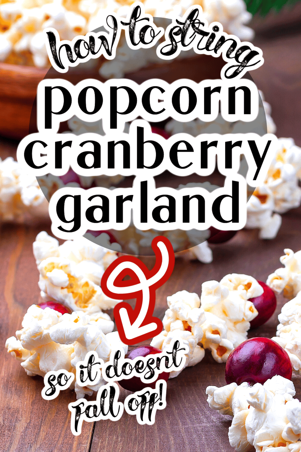 how to string popcorn and cranberries - cranberry popcorn garland on a table with text over the garland picture