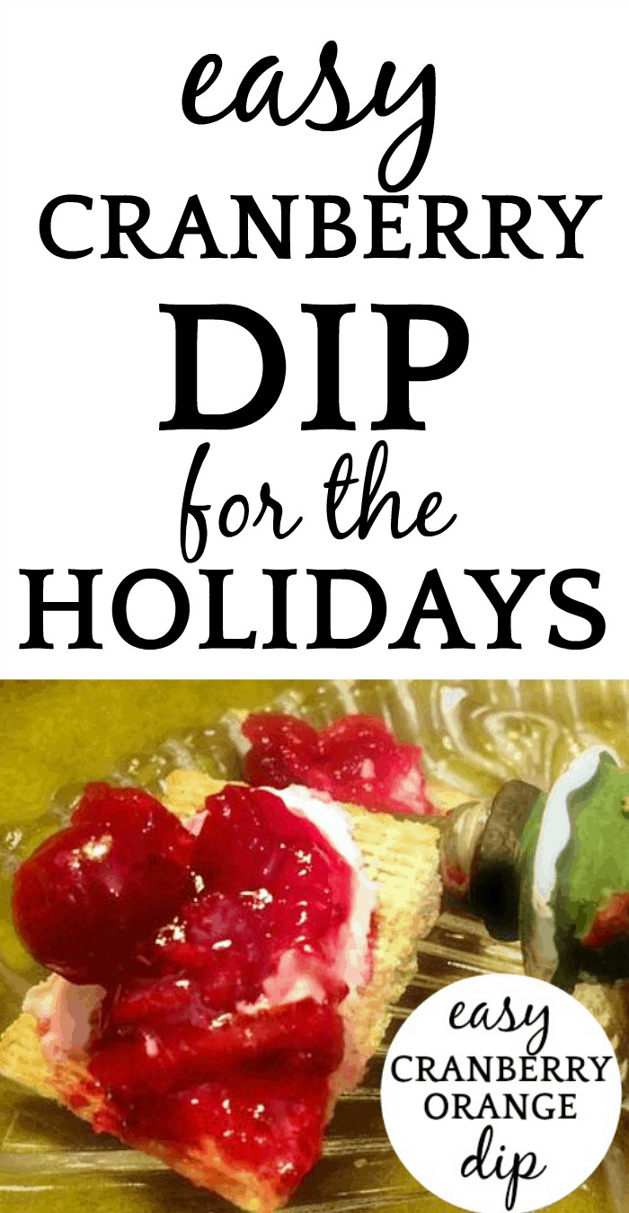 Easy Orange Cranberry Cream Cheese Dip on a cracker on a festive holiday plate