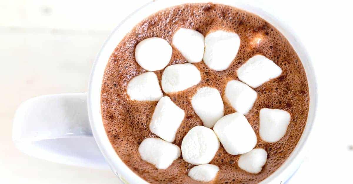 Homemade Hot Chocolate Without Hot Chocolate Mix (how to make hot chocolate from cocoa powder) top down view of hot chocolate homemade in white mug with mini marshmallows