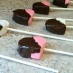 How To Make Marshmallow Pops pink and white heart marshmallows dipped in chocolate on one side
