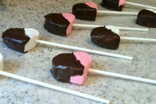 How To Make Marshmallow Pops pink and white heart marshmallows dipped in chocolate on one side