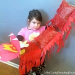 little girl holding a DIY easy chinese dragon craft