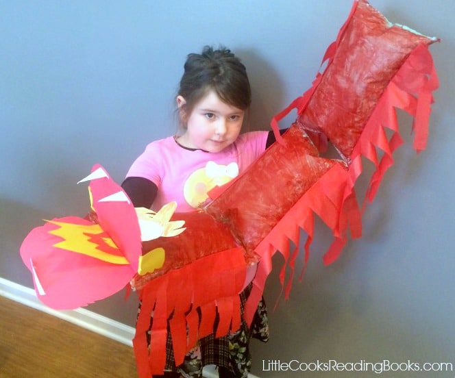 little girl holding a DIY easy chinese dragon craft