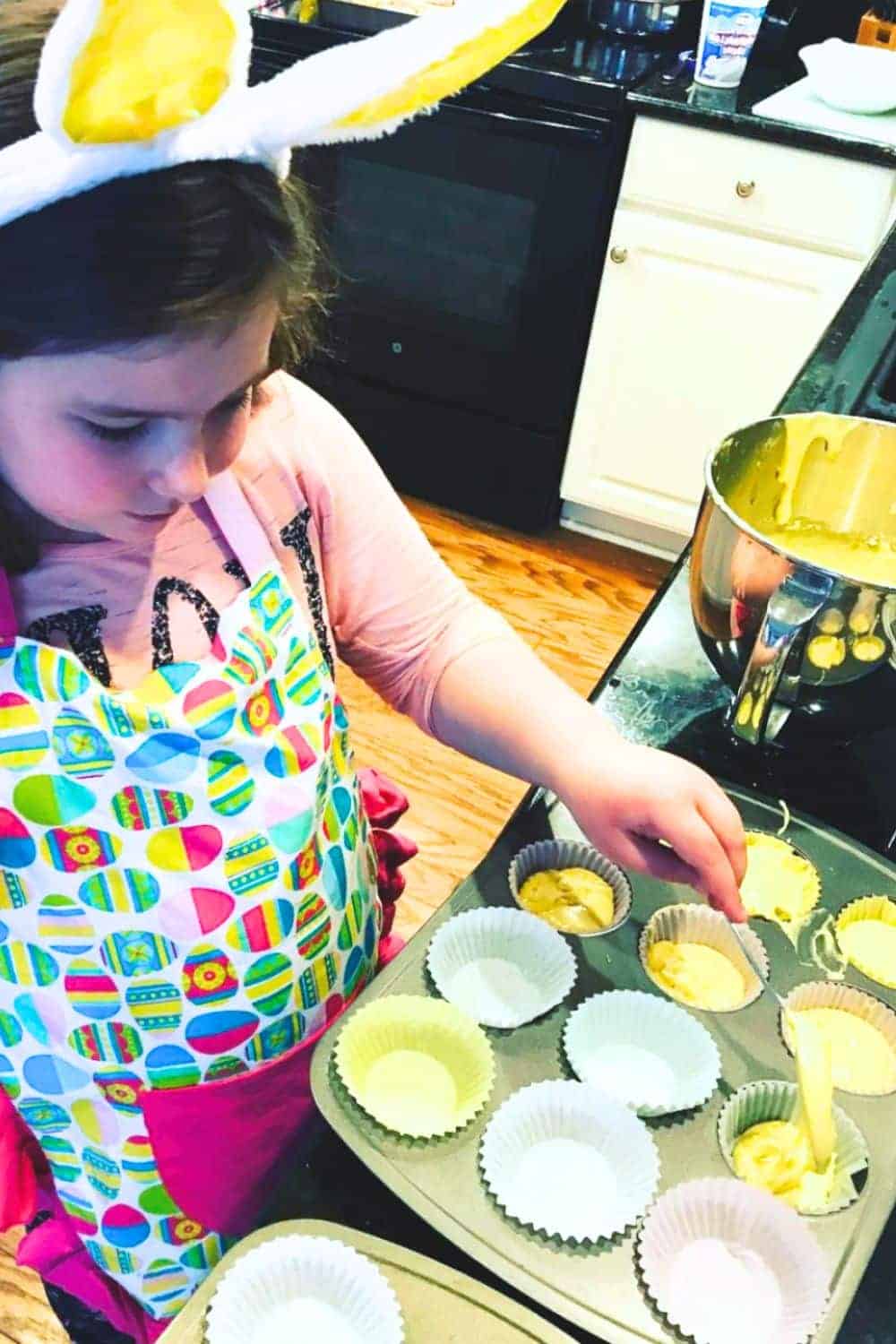 How To Make Yellow Chickens Cupcakes Step By Step With Printable Recipe Card child making spooning cake batter mix into cupcake holders