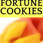 homemade yellow fortune cookie with a pink fortune cookie behind it