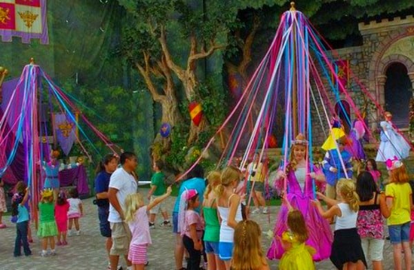 Maypole Dance KIDS DANCING AROUND THE MAY POLE AND HOLDING COLORFUL MAYPOLE RIBBONS