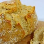 Sourdough Starter Bread Recipe loaf of sourdough bread on brown cutting board