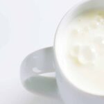 how to make buttermilk homemade with curdled buttermilk sitting in a white mug on a white background