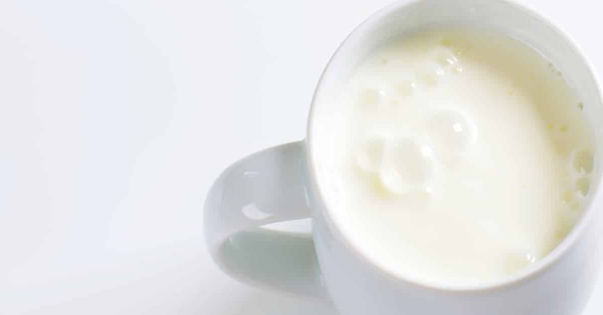 how to make buttermilk homemade with curdled buttermilk sitting in a white mug on a white background