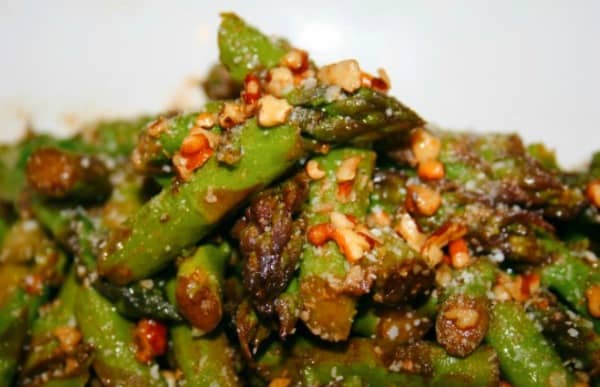 Simple Asparagus Salad close up of green asparagus with nuts and parmesan cheese sprinkled on top