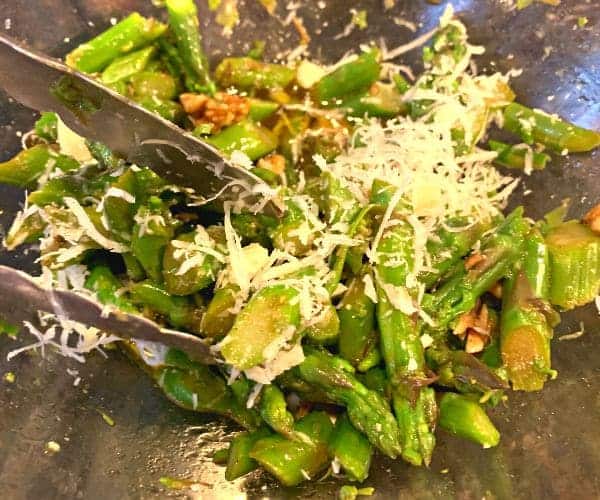 Simple Asparagus Vegetable Salad in a bowl topped with shaved parmesan cheese