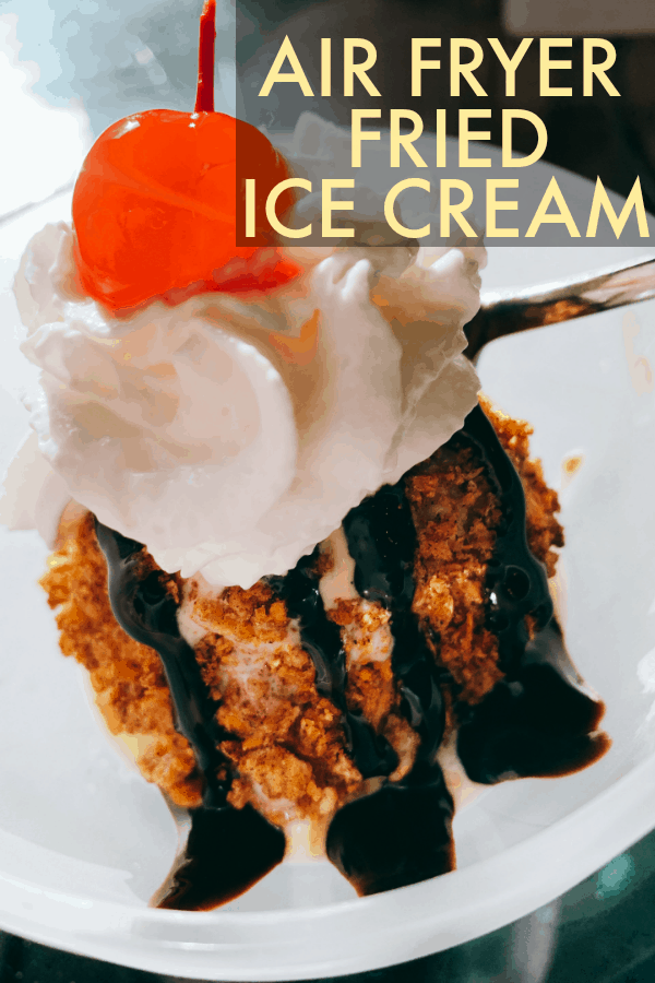 Recipe For Fried Ice Cream in the Air Fryer (easy air fryer deep fried ice cream) text over fried ice cream in white bowl with chocolate syrup drizzle, whipped cream and cherry on top