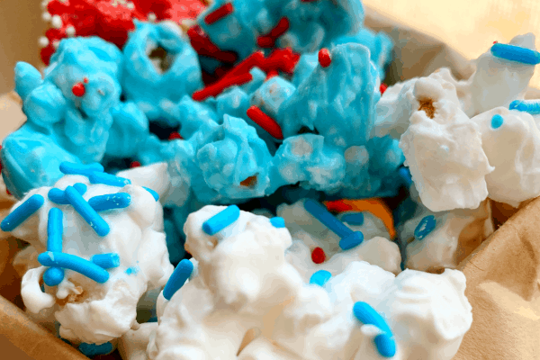 white chocolate popcorn in white, blue, and red with sprinkles