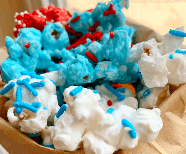 white chocolate popcorn in white, blue, and red with sprinkles