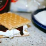 smores on a counter with marshmallow and chocolate dripping down