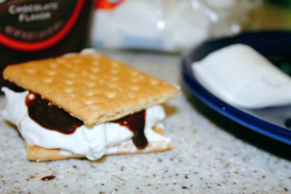 smores on a counter with marshmallow and chocolate dripping down