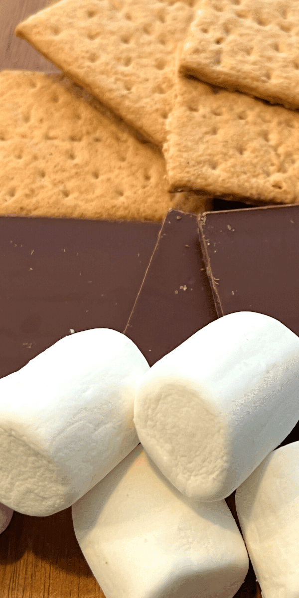 What do you need to make s'mores marshmallows chocolate bars and graham cracker squares on cutting board