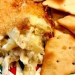 Easy Artichoke Dip Recipe on a plate with crackers
