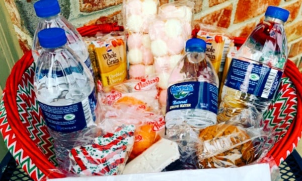 snack basket for delivery people with an assortment of snack cakes and bottle waters