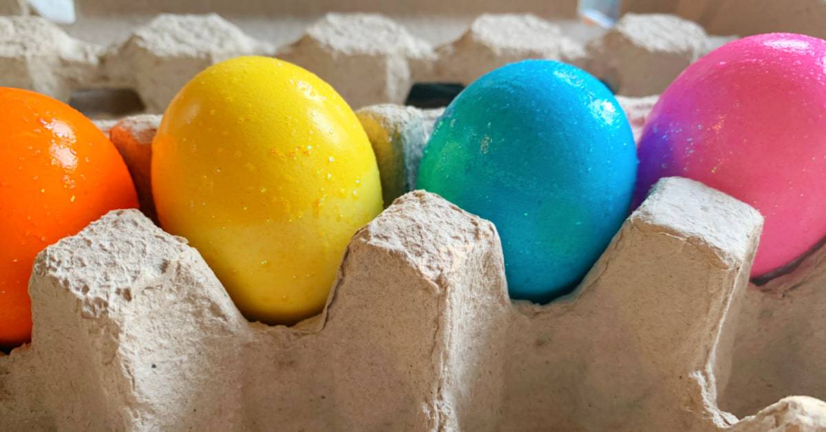 How to dye eggs with food color: Using food color to dye eggs vibrant colored easter eggs sitting in an egg carton