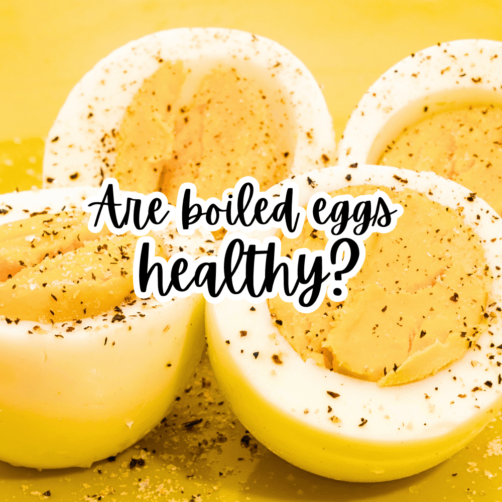 Are Boiled Eggs Healthy text over cut open hard boiled eggs on a table