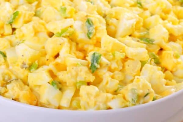 Best Egg Salad Recipes close up of classic egg salad recipe in white bowl