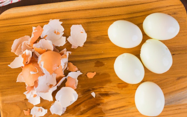 how to make the best easy peel hard boiled eggs - eggs on a cutting board