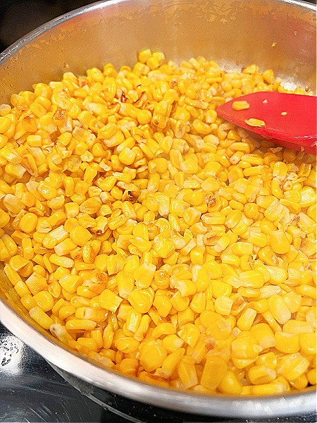 What's the difference between Elotes and Esquites? (Ideas for corn kernel recipes) yellow corn frying in a pan
