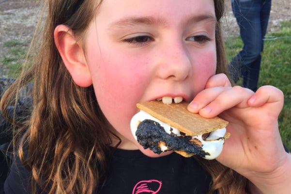 how to make smores with child eating a smores dessert