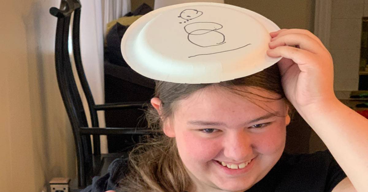 Snowman Paper Plate Game with teen girl laughing