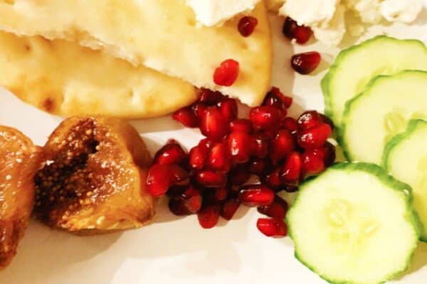 how to roast dried figs on plate with pomegranate seeds naan and cucumbers