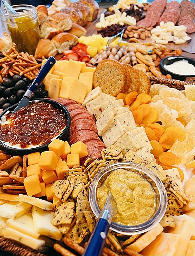 How do you make a grazing board - close up of a charcuterie board with meats, cheeses and dips