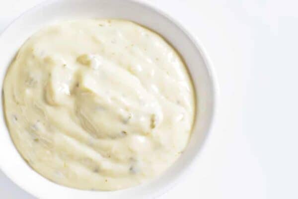 The Best Homemade Ranch Salad Dressing [Homemade Dry Ranch Mix Recipe] ranch dressing in a white bowl on a white table