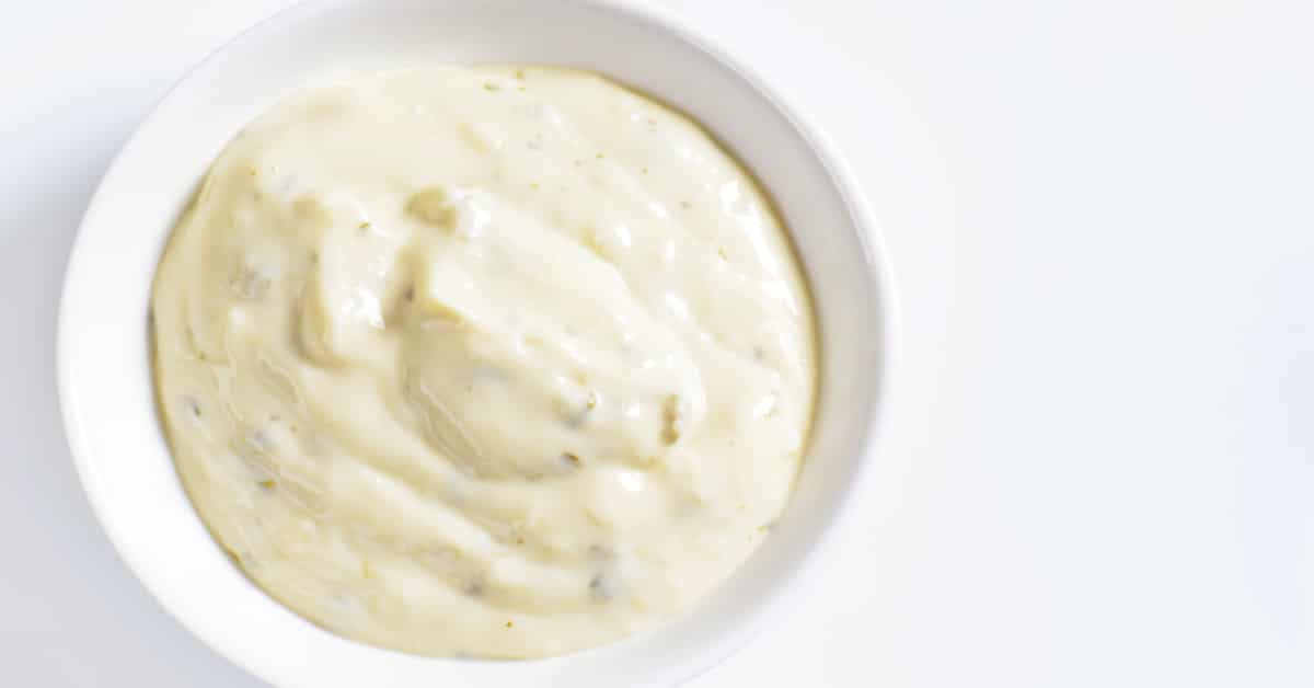 The Best Homemade Ranch Salad Dressing [Homemade Dry Ranch Mix Recipe] ranch dressing in a white bowl on a white table