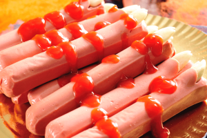 Halloween mystery food game hotdog fingers with blood ketchup on a platter