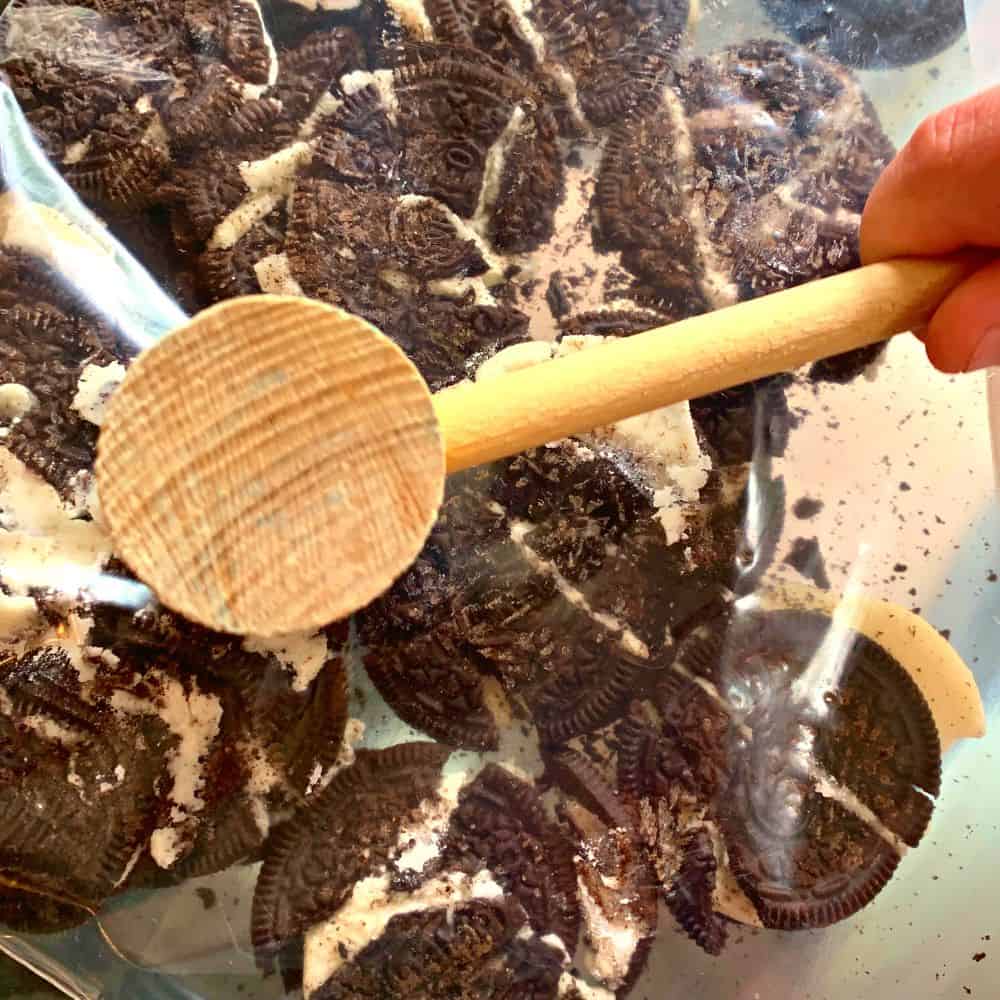 How To Crush Oreos Without A Food Processor hand crushing Oreo cookies in a plastic bag